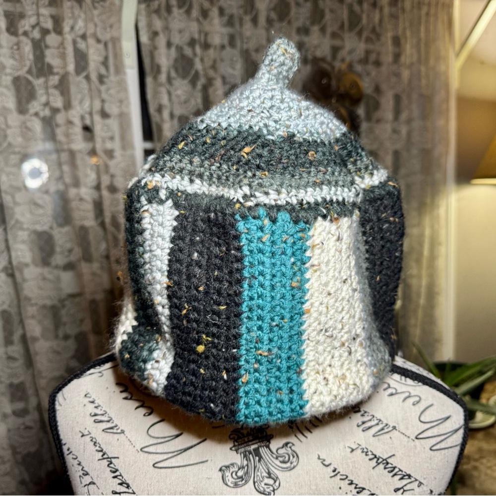 Black and Green Crocheted Hat with Cozy Texture and Conical Shape